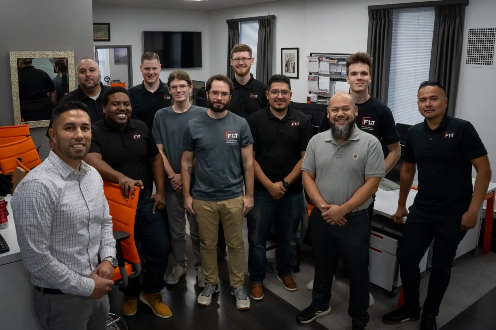 The full F1 iT team posing together in the company office